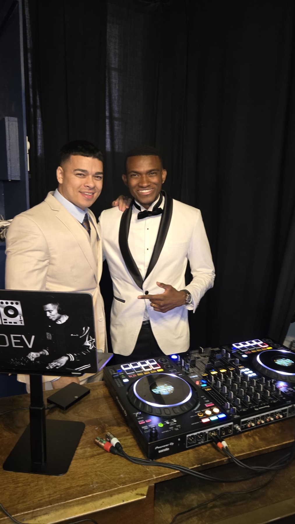 DJ Dev with wedding guests beside a professional DJ setup